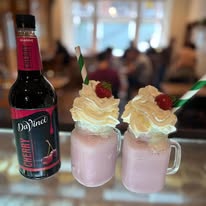 Cherry milkshakes topped with cream